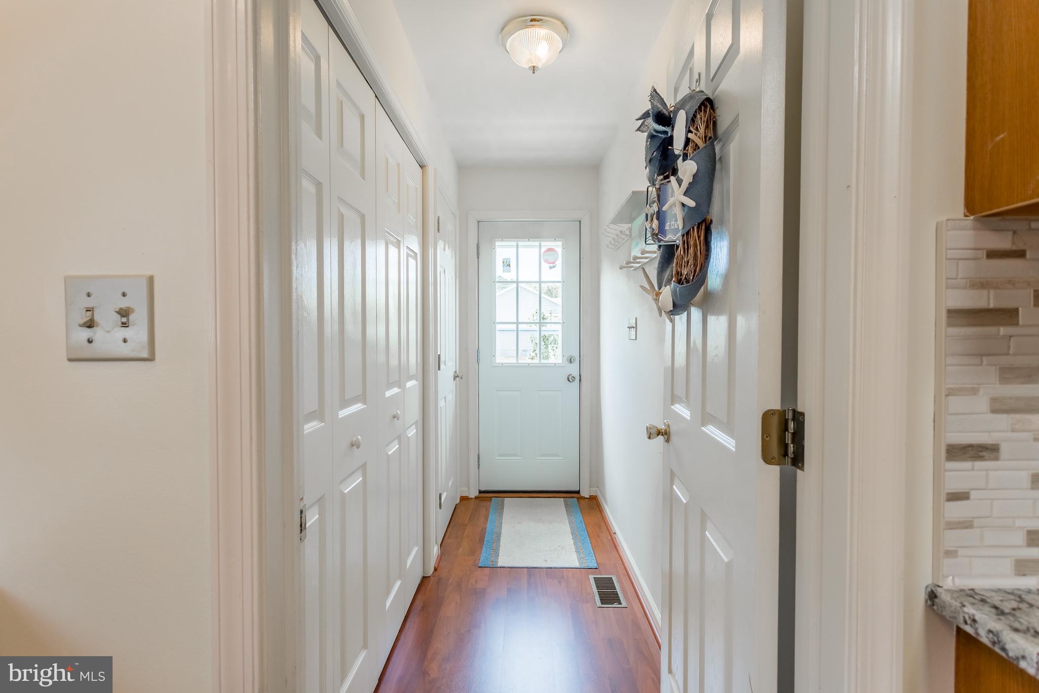 24174 Zoar Road Georgetown, DE 19947 - Photo 15 of 32 SIDE DOOR AND HALL LEADING TO KITCHEN