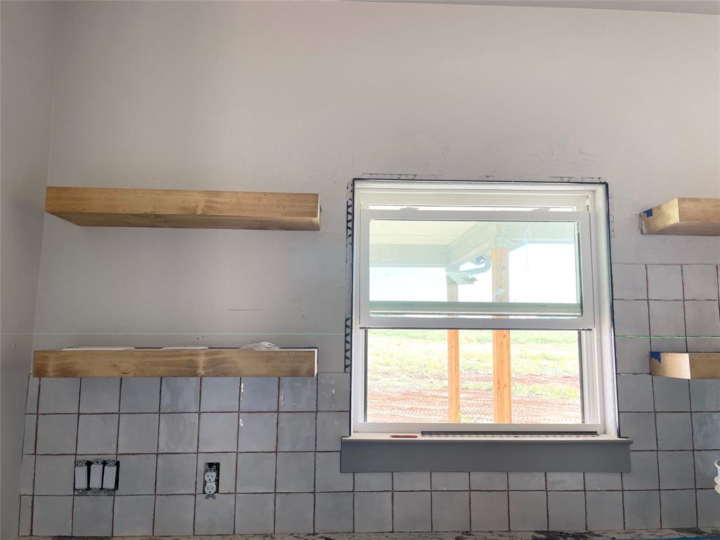 159 Lake Valley Road Sunset, TX 76270 - Photo 12 of 34 Tile being installed and will be up to the ceiling, work in progress