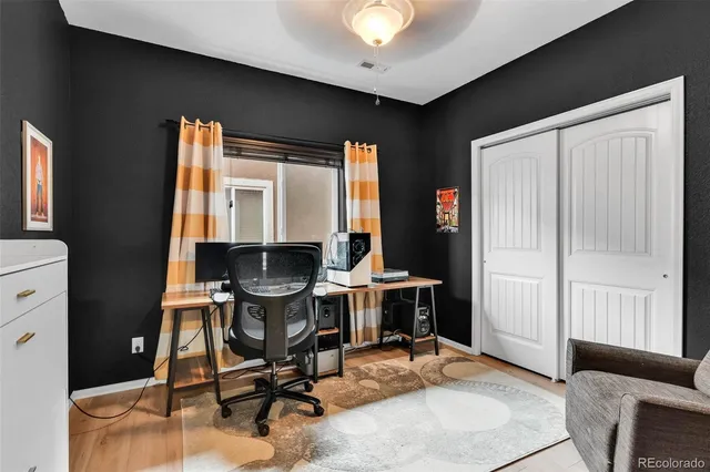 a view of a workspace with furniture and a window