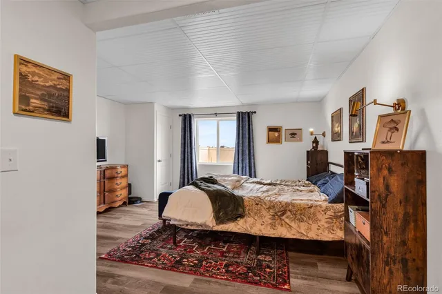 a bedroom with furniture and wooden floor