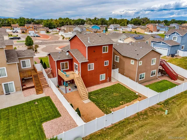 an aerial view of residential houses with yard
