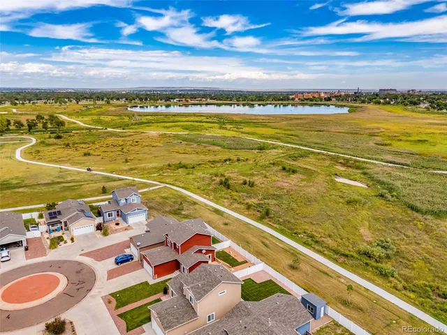 a view of a ocean from a dining room with furniture