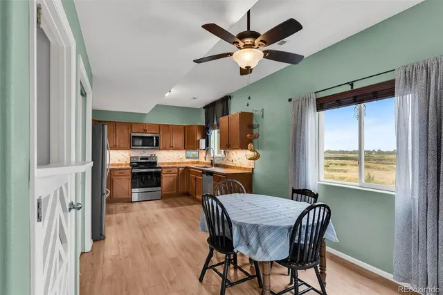 a view of a dining room with furniture window and wooden floor