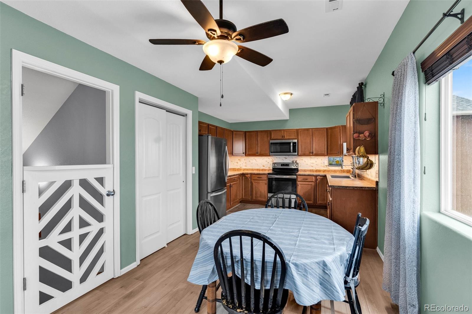2108 O'Neal Circle Pueblo, CO 81004 - Photo 9 of 39 a view of a dining room with furniture window and wooden floor
