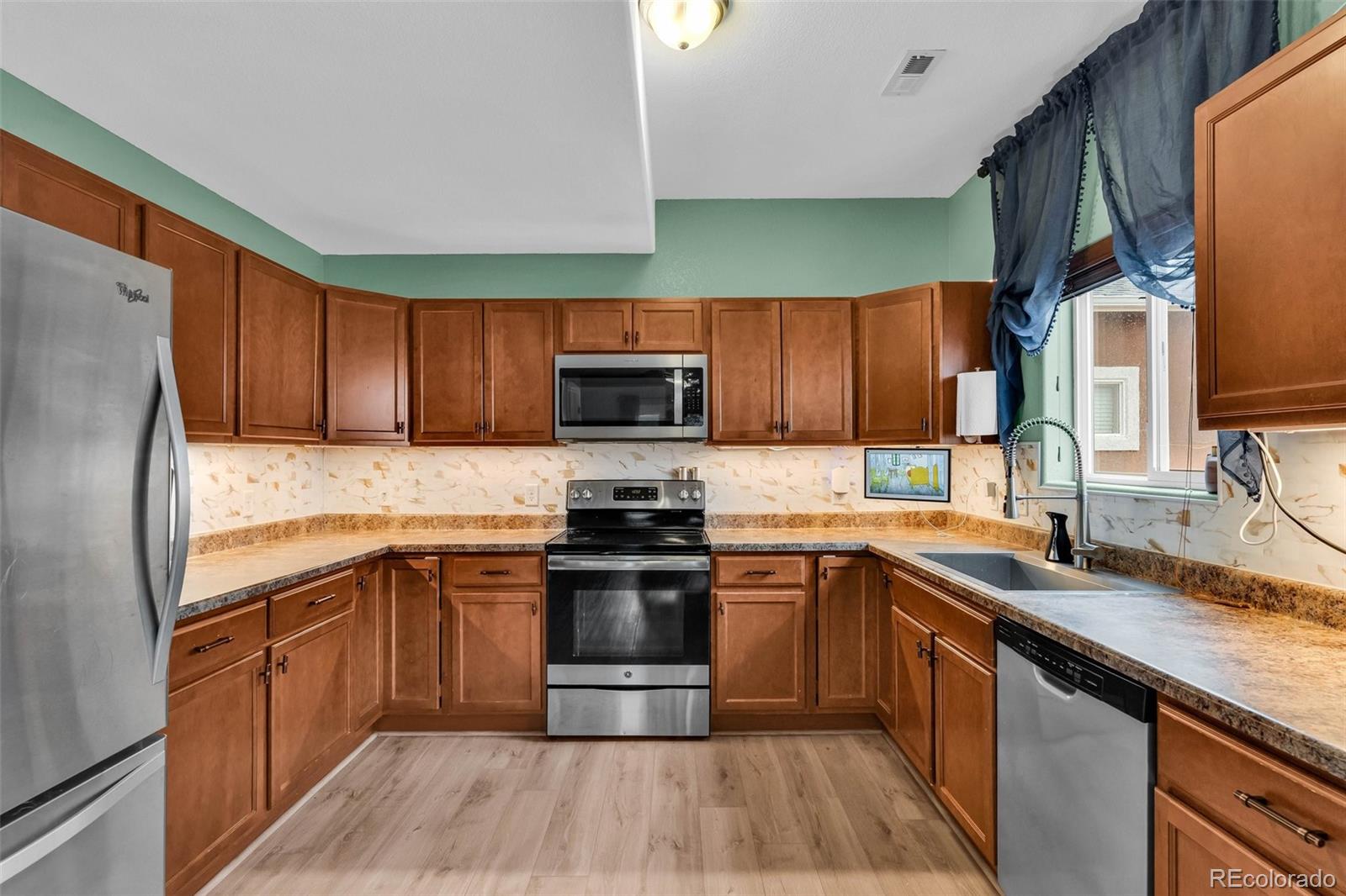 2108 O'Neal Circle Pueblo, CO 81004 - Photo 10 of 39 a kitchen with a sink stove microwave and refrigerator