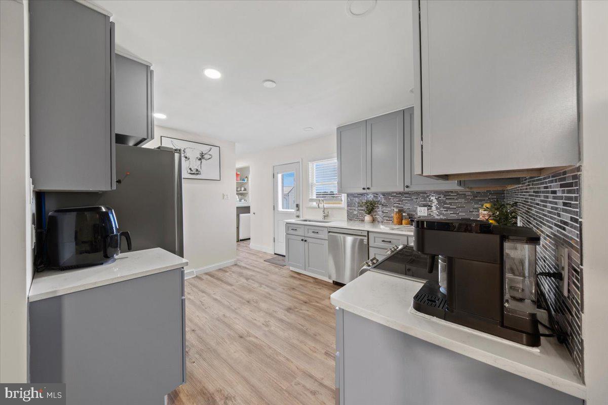 484 Centerton Road Bridgeton, NJ 08302 - Photo 12 of 49 a kitchen with a sink a stove and refrigerator