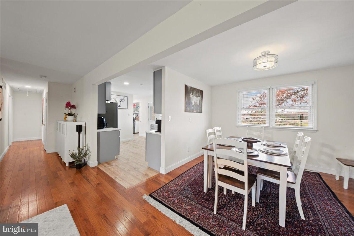 484 Centerton Road Bridgeton, NJ 08302 - Photo 8 of 49 a dining room with wooden floor and white walls