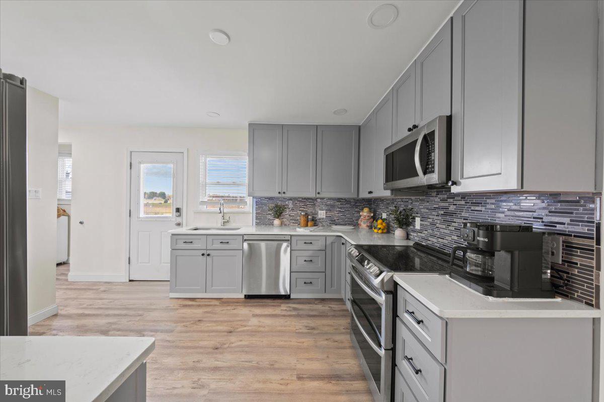 484 Centerton Road Bridgeton, NJ 08302 - Photo 9 of 49 a kitchen with a sink stove and cabinets