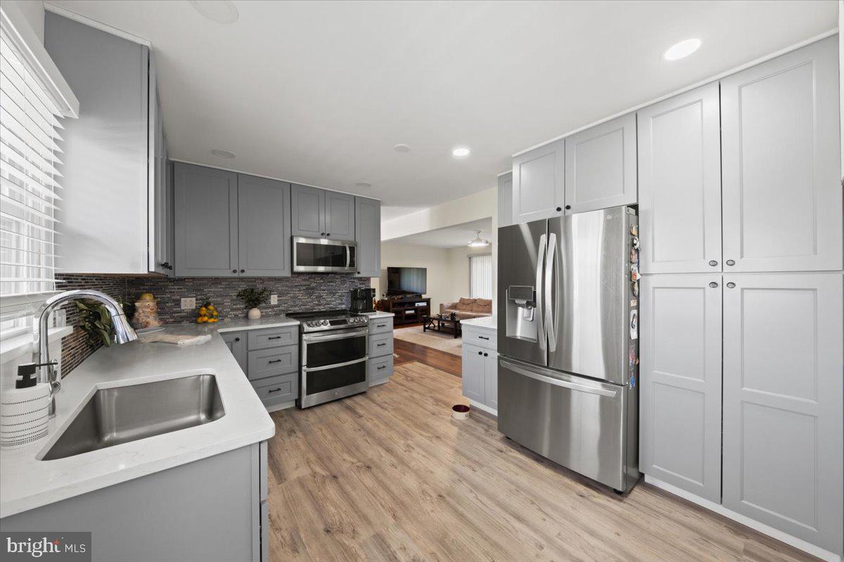 484 Centerton Road Bridgeton, NJ 08302 - Photo 10 of 49 a kitchen with wooden cabinets and stainless steel appliances