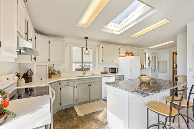 a kitchen that has a lot of cabinets in it and appliances