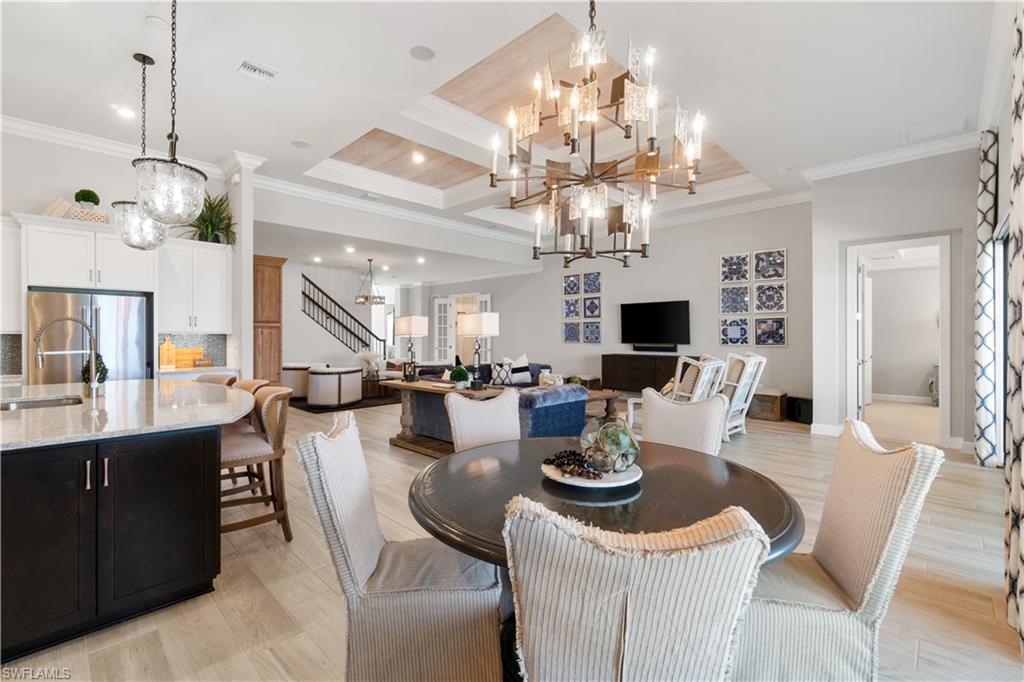 14367 Pine Hollow Drive Estero, FL 33928 - Photo 15 of 50 a view of a dining room with furniture a chandelier and wooden floor