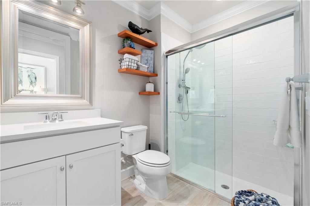 14367 Pine Hollow Drive Estero, FL 33928 - Photo 19 of 50 a bathroom with a shower sink vanity mirror and toilet