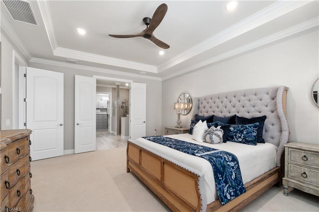 14367 Pine Hollow Drive Estero, FL 33928 - Photo 22 of 50 a bedroom with a large bed and a chandelier