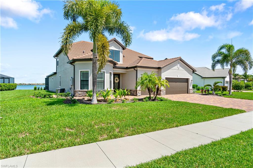 14367 Pine Hollow Drive Estero, FL 33928 - Photo 3 of 50 a front view of a house with a yard