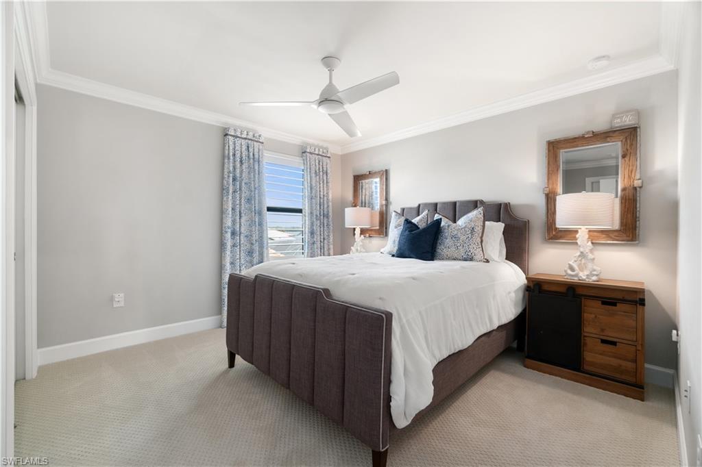 14367 Pine Hollow Drive Estero, FL 33928 - Photo 32 of 50 a bedroom with a large bed and a chandelier