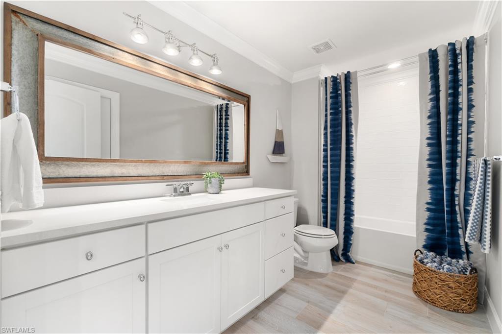 14367 Pine Hollow Drive Estero, FL 33928 - Photo 33 of 50 a bathroom with a sink a toilet and a mirror