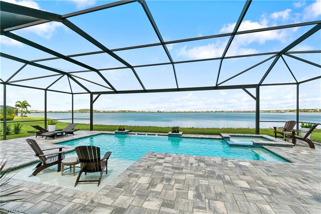 14367 Pine Hollow Drive Estero, FL 33928 - Photo 40 of 50 a swimming pool with outdoor seating and yard