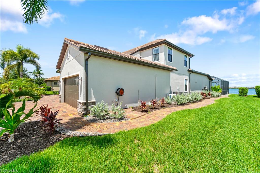 14367 Pine Hollow Drive Estero, FL 33928 - Photo 4 of 50 a view of a house with yard and plants