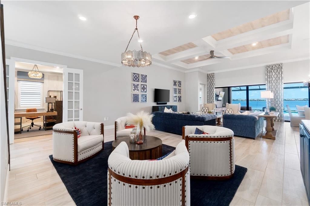 14367 Pine Hollow Drive Estero, FL 33928 - Photo 9 of 50 a living room with furniture kitchen view and a chandelier