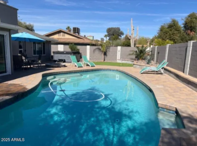 a view of a swimming pool with a patio
