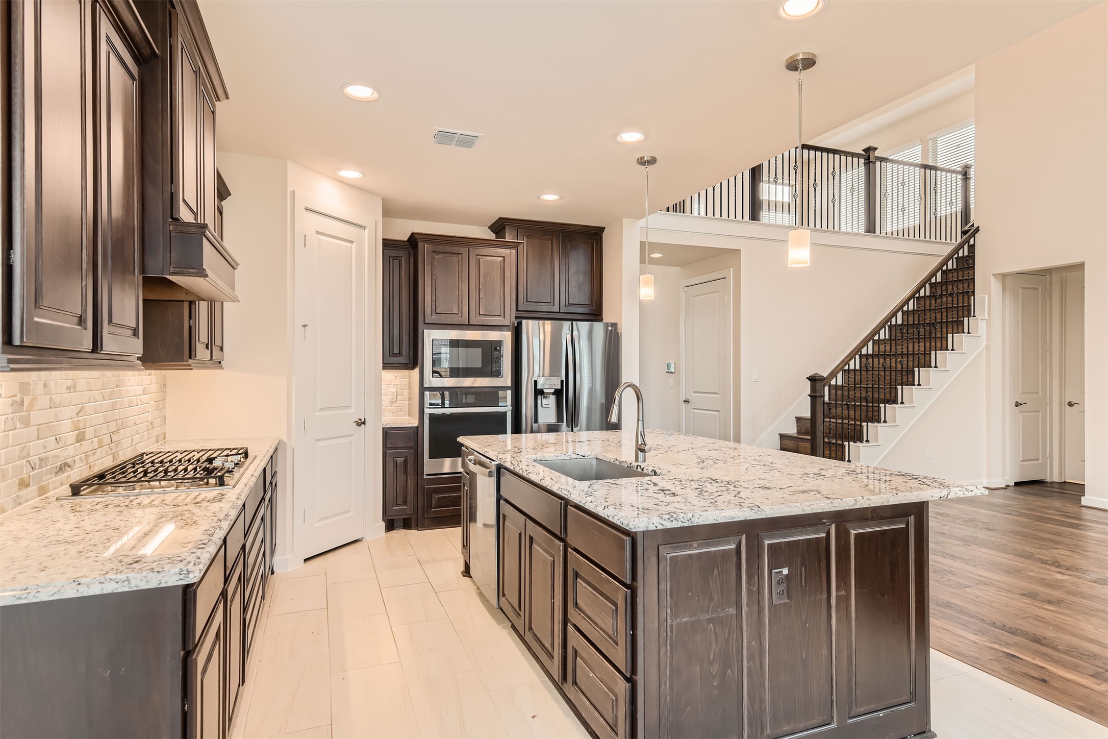 8313 Spire View Austin, TX 78744 - Photo 12 of 33 Culinary delights await in this modern kitchen with rich cabinetry and an inviting island.