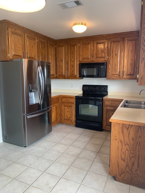 618 General George Patton Road Nashville, TN 37221 - Photo 9 of 26 a kitchen with granite countertop a refrigerator and a stove top oven