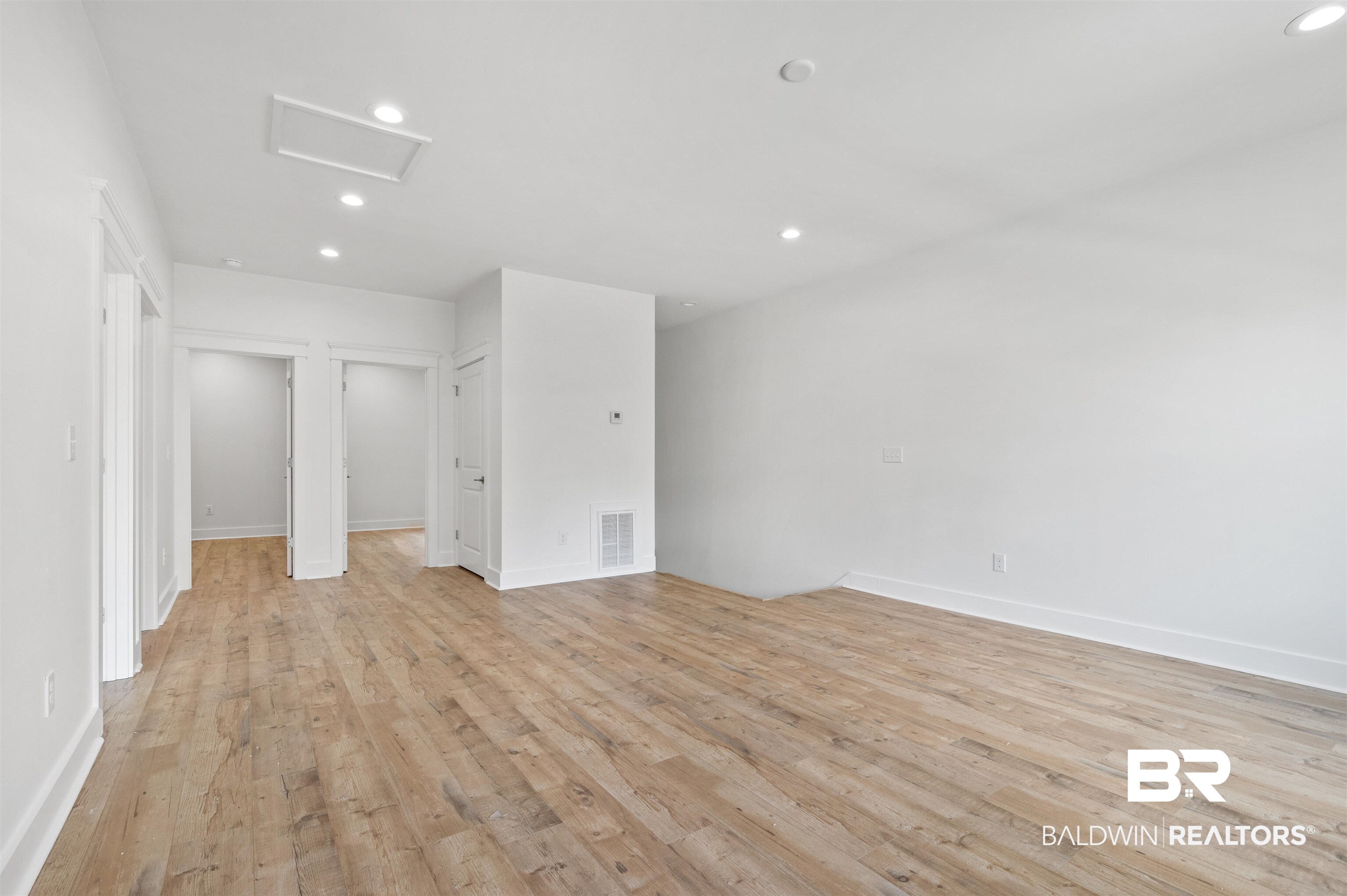 657 Island Way Gulf Shores, AL 36542 - Photo 28 of 59 Spare room featuring attic access, recessed lighting, light wood-style floors, and baseboards