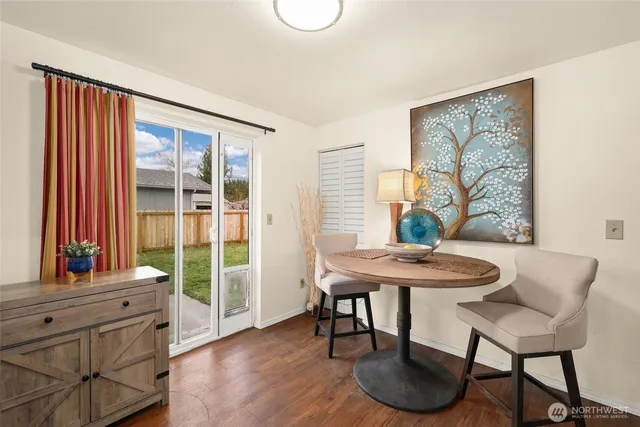a view of a dining room with furniture and a window