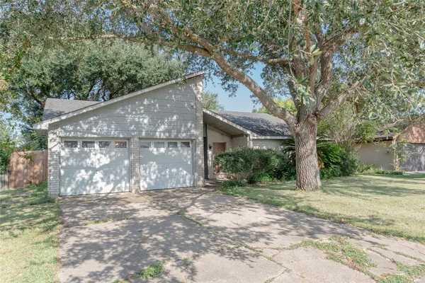 a view of a house with a tree in the background