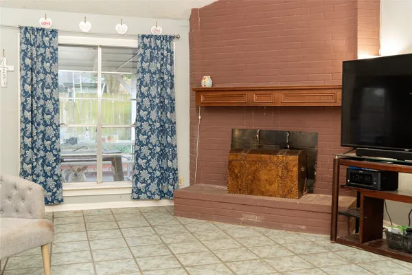 a living room filled with furniture and a flat screen tv