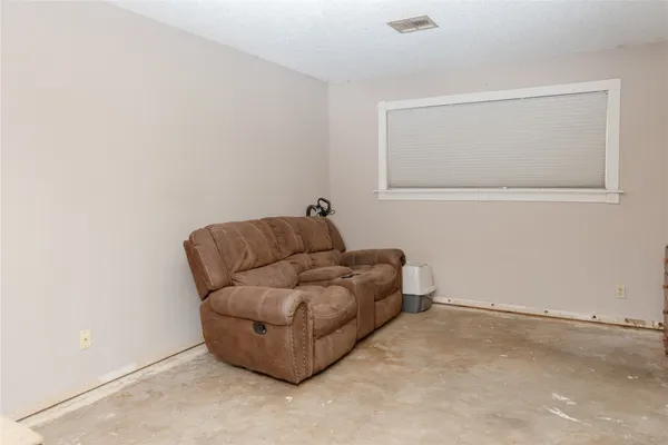 a living room with furniture and a wall painting