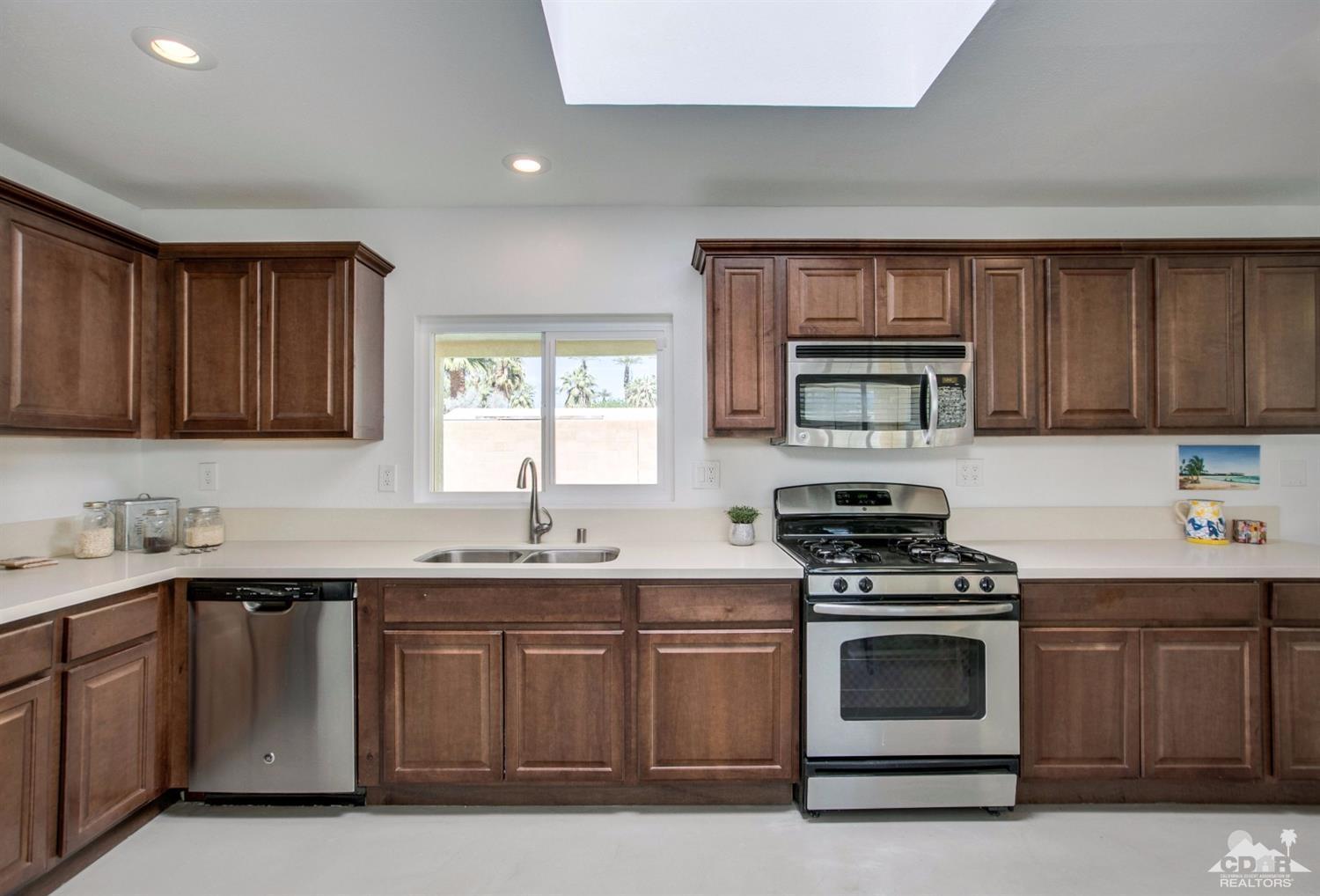 70070 Chappel Road Rancho Mirage, CA 92270 - Photo 11 of 32 a kitchen with a sink stove and microwave