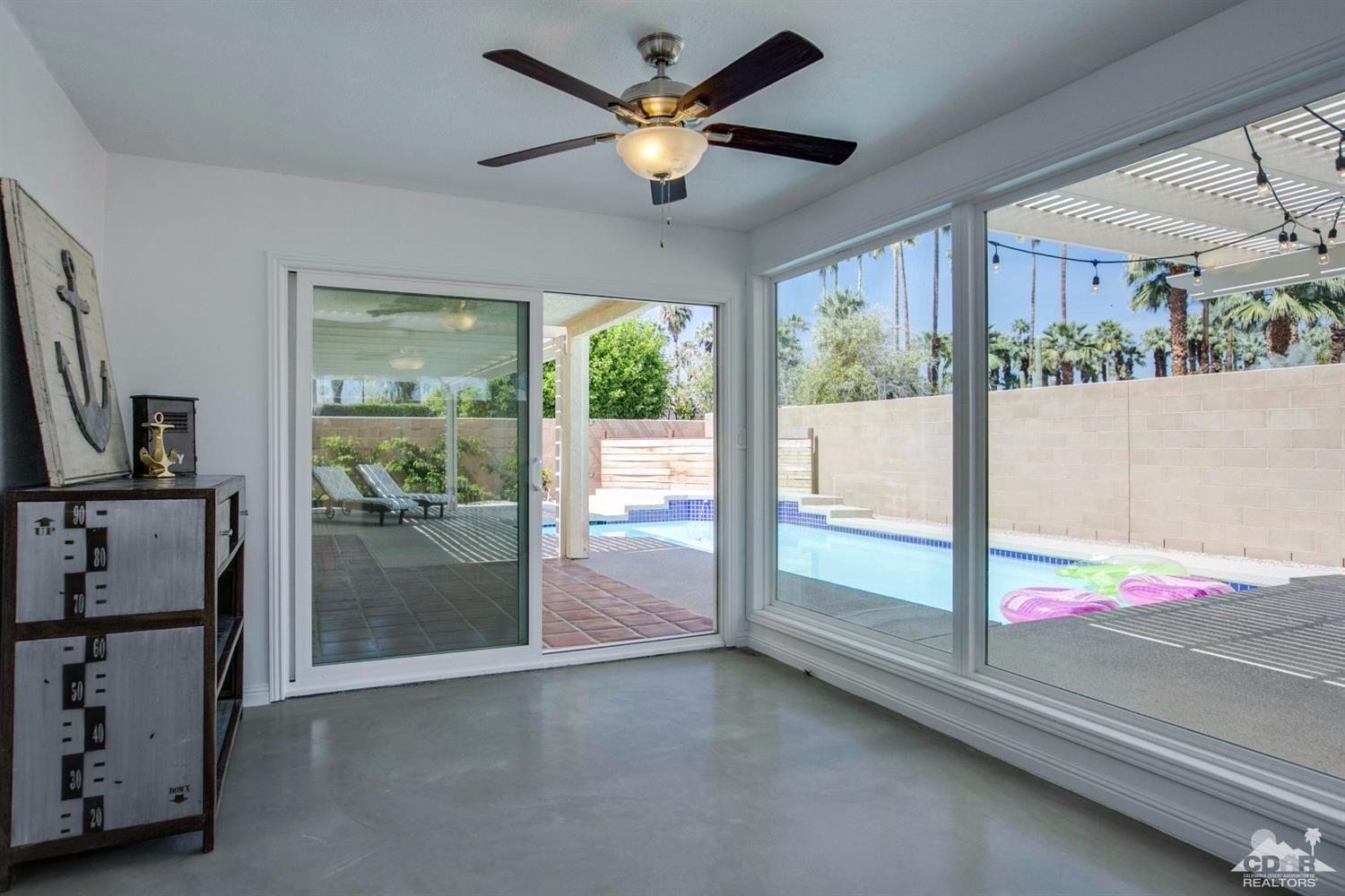 70070 Chappel Road Rancho Mirage, CA 92270 - Photo 15 of 32 a view of an empty room with a floor to ceiling window and a flat screen tv