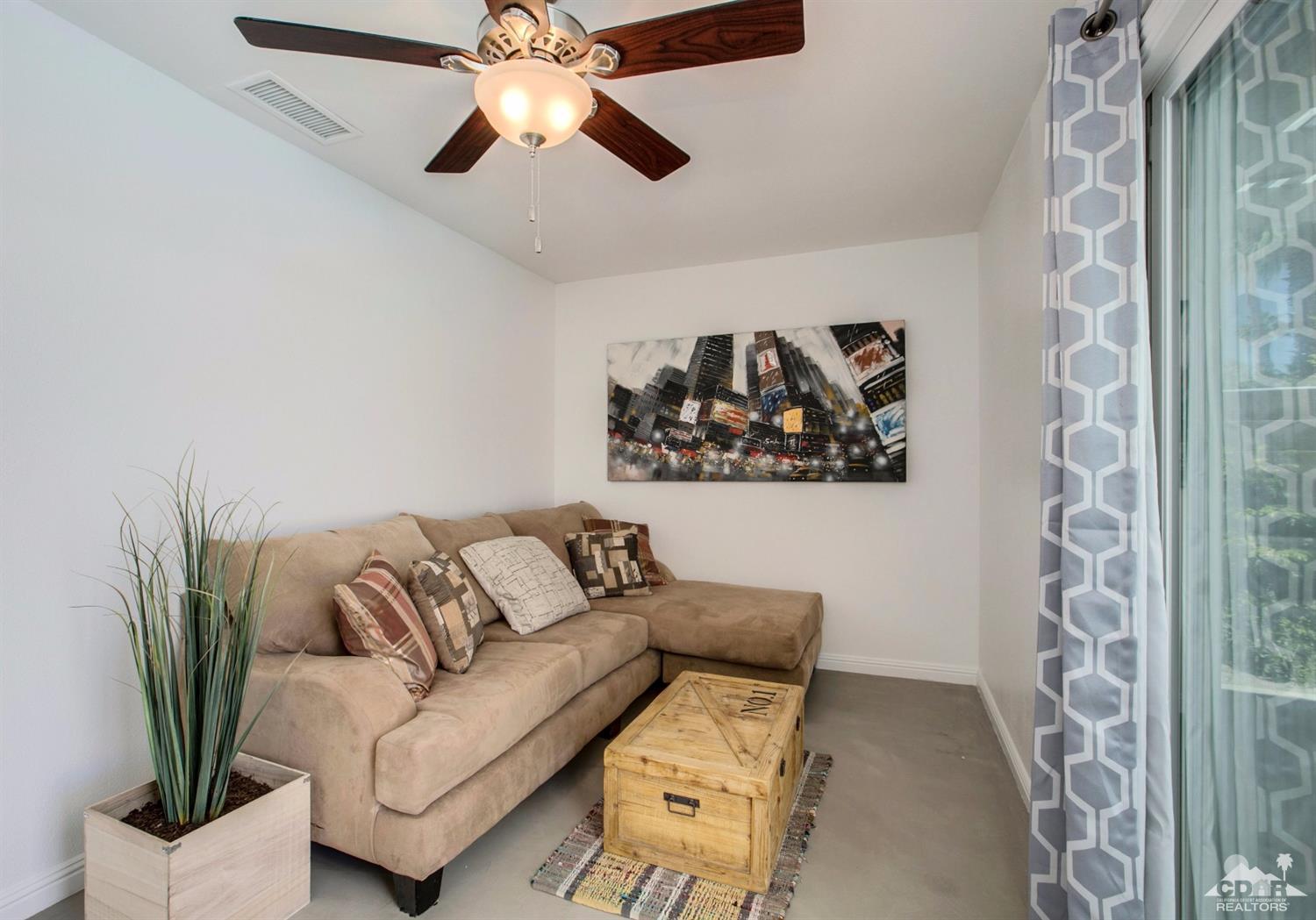 70070 Chappel Road Rancho Mirage, CA 92270 - Photo 18 of 32 a living room with furniture and a potted plant