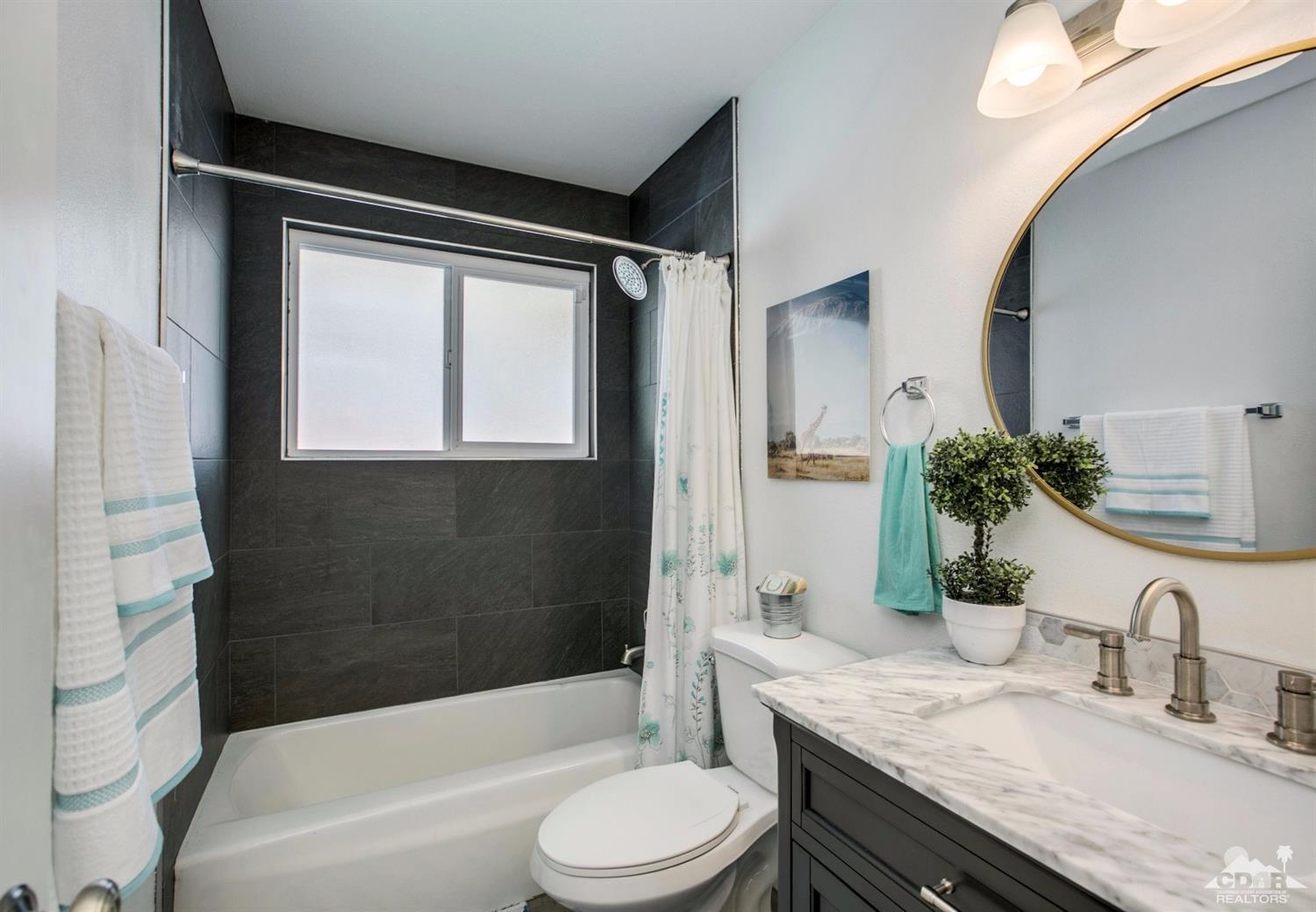 70070 Chappel Road Rancho Mirage, CA 92270 - Photo 20 of 32 a bathroom with a granite countertop sink toilet and shower