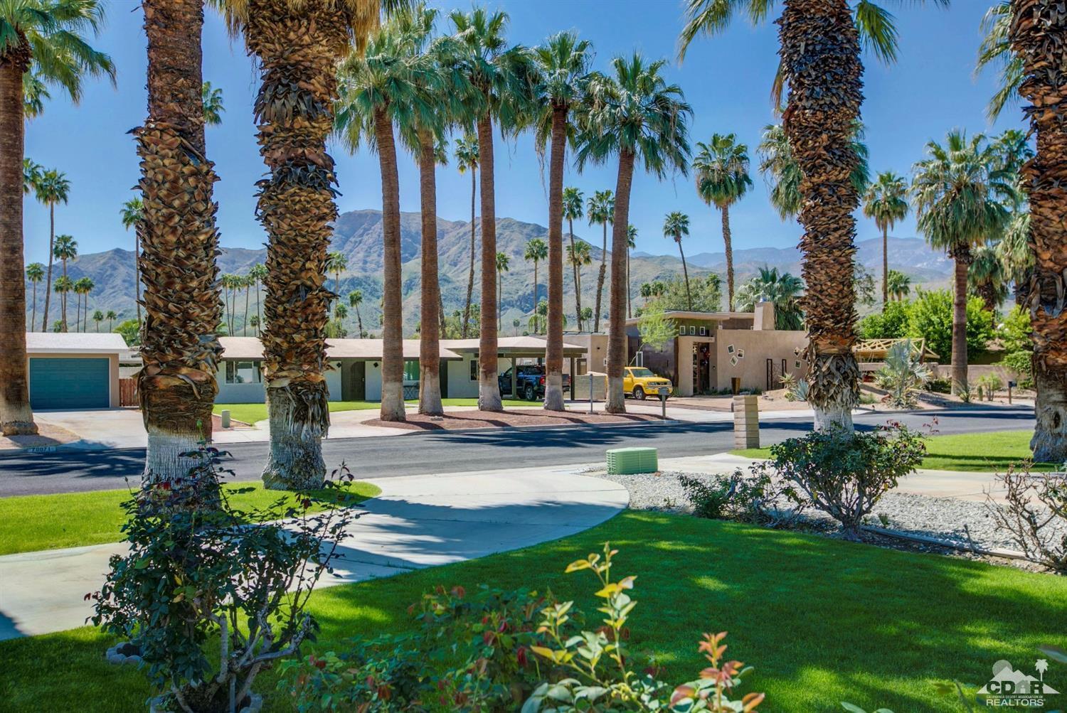 70070 Chappel Road Rancho Mirage, CA 92270 - Photo 2 of 32 a view of a swimming pool with a garden and patio