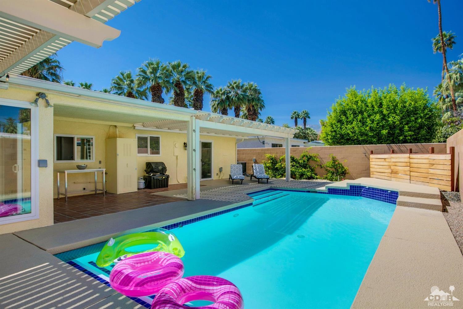 70070 Chappel Road Rancho Mirage, CA 92270 - Photo 28 of 32 a view of a house with a swimming pool