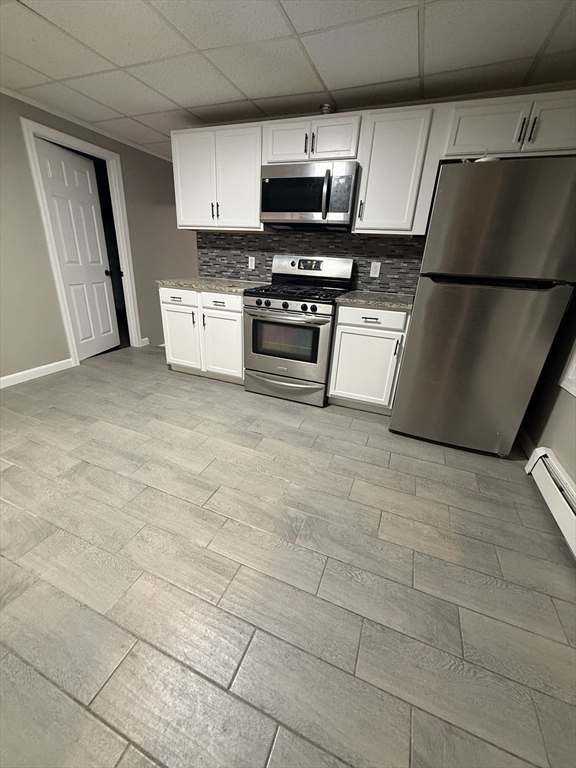 a kitchen with stainless steel appliances a refrigerator sink and microwave
