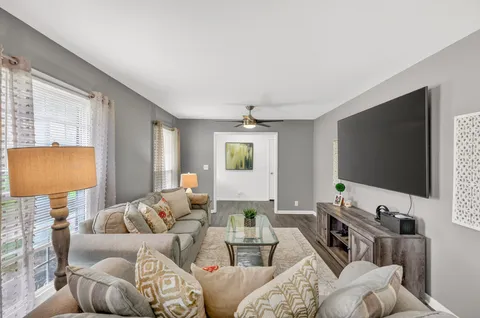 a living room with furniture and a flat screen tv
