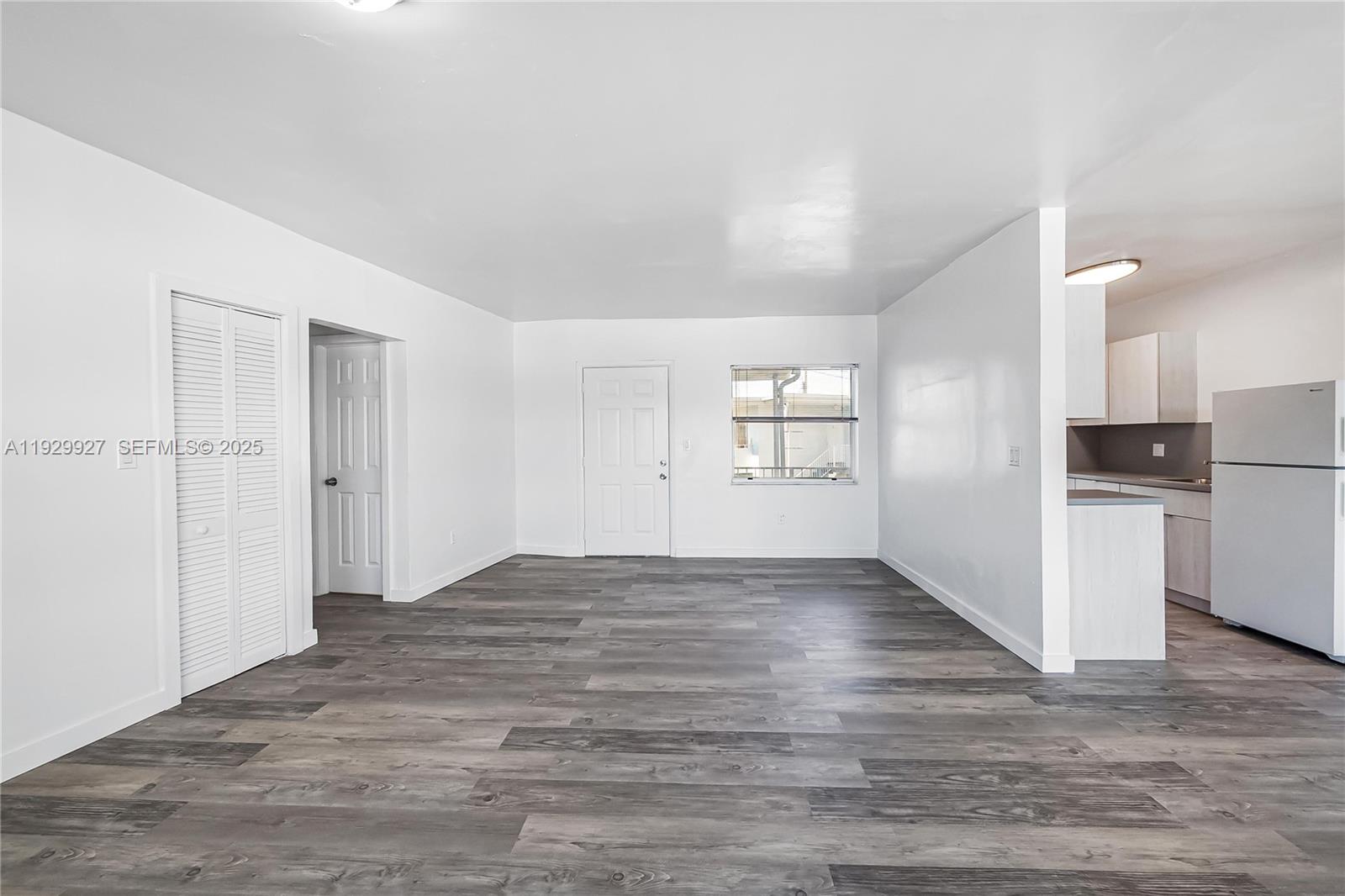 7271 Gary Avenue, Unit 6 Miami Beach, FL 33141 - Photo 11 of 23 a view of empty room with wooden floor and kitchen
