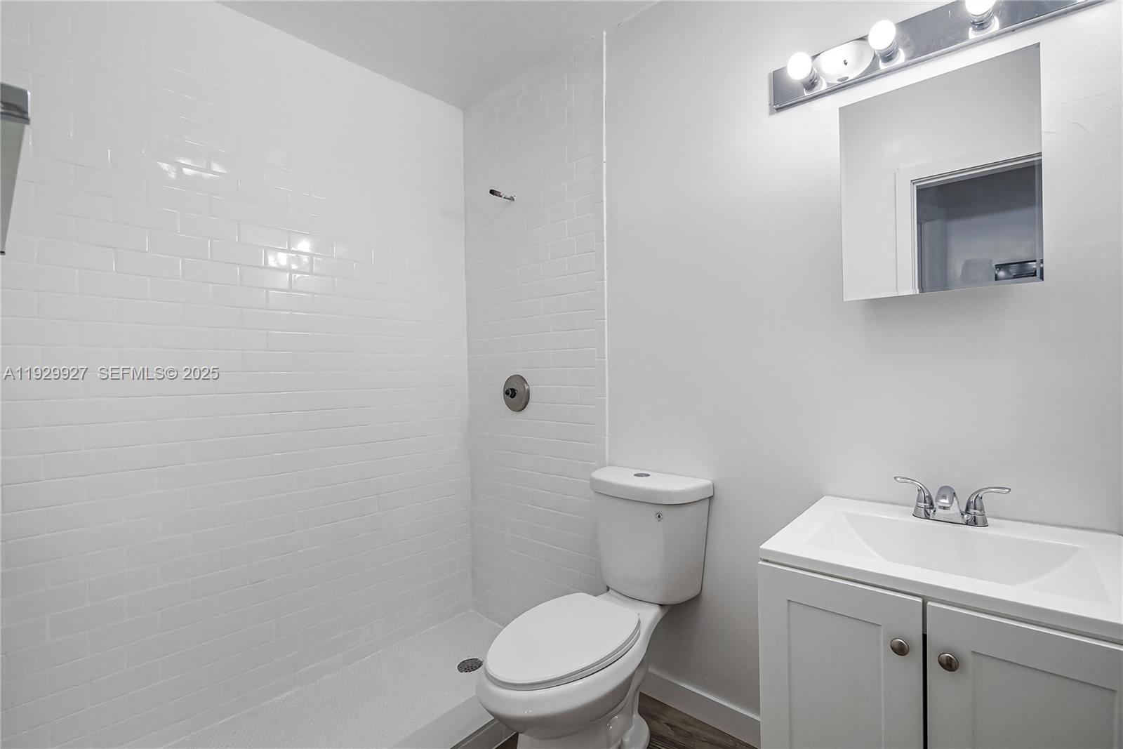 7271 Gary Avenue, Unit 6 Miami Beach, FL 33141 - Photo 13 of 23 a white toilet sitting next to a bathroom sink