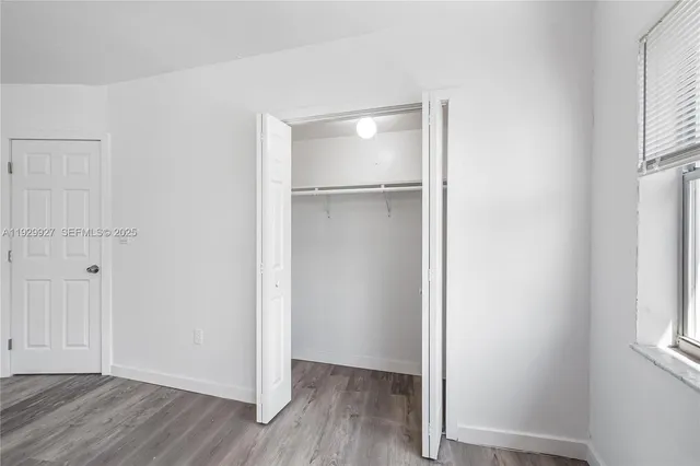 an empty room with wooden floor