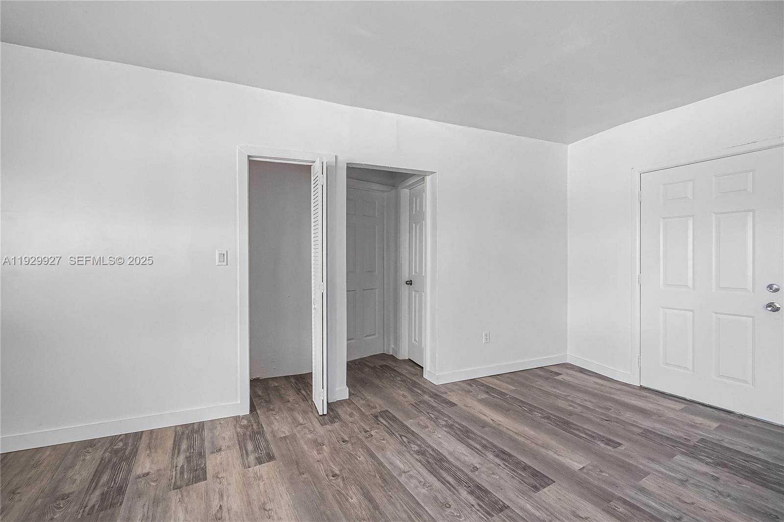 7271 Gary Avenue, Unit 6 Miami Beach, FL 33141 - Photo 19 of 23 an empty room with wooden floor