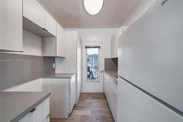 a kitchen with a sink and a refrigerator
