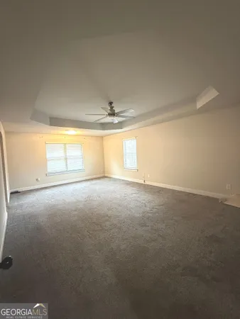 an empty room with a empty space and windows