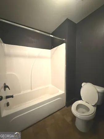 a bathroom with a toilet and a bathtub
