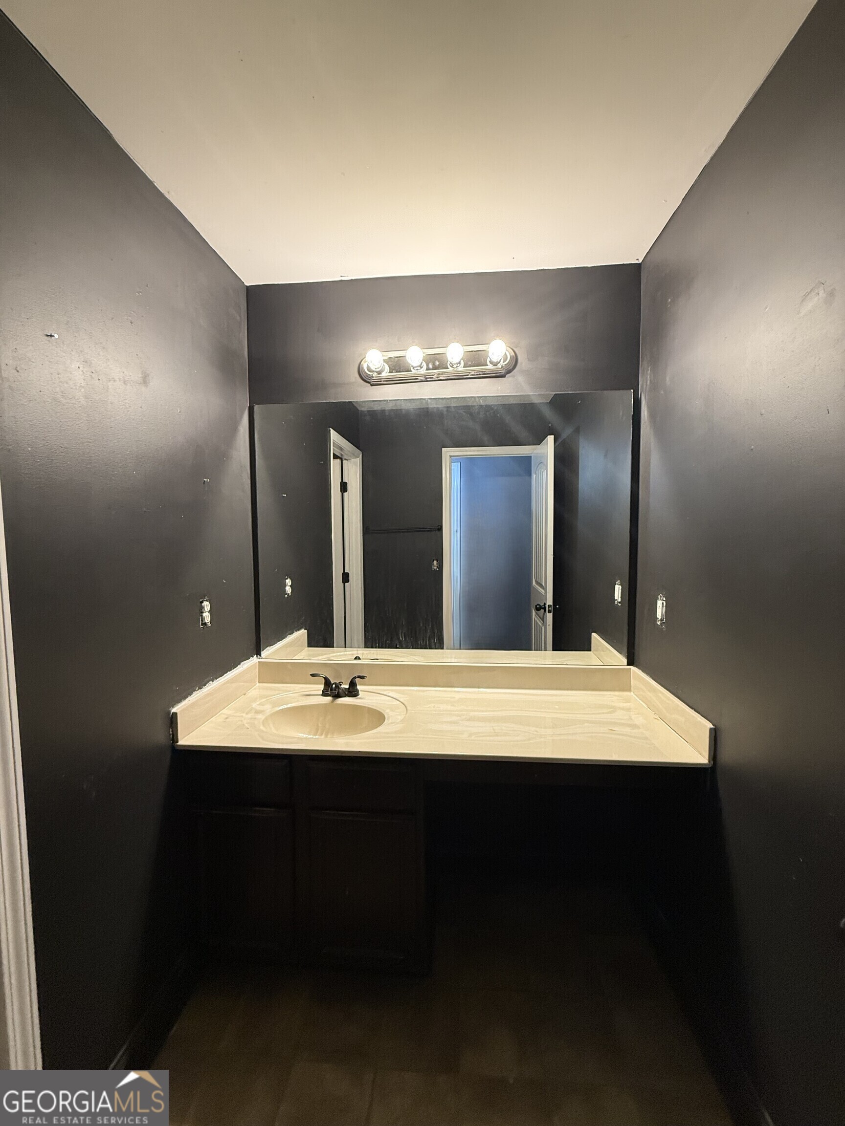 9159 Dover Street Lithia Springs, GA 30122 - Photo 10 of 23 a room with a sink vanity and a mirror