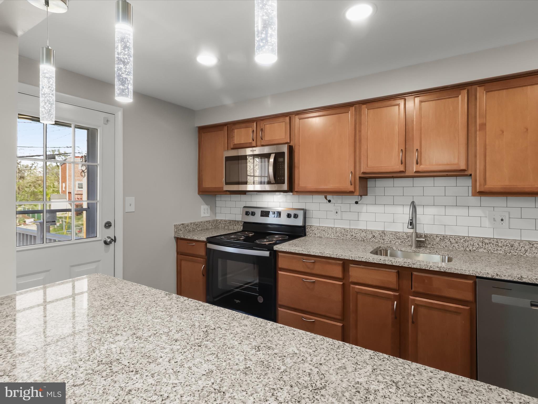 1026 Circle Drive Halethorpe, MD 21227 - Photo 14 of 37 a kitchen with stainless steel appliances granite countertop a sink stove and microwave