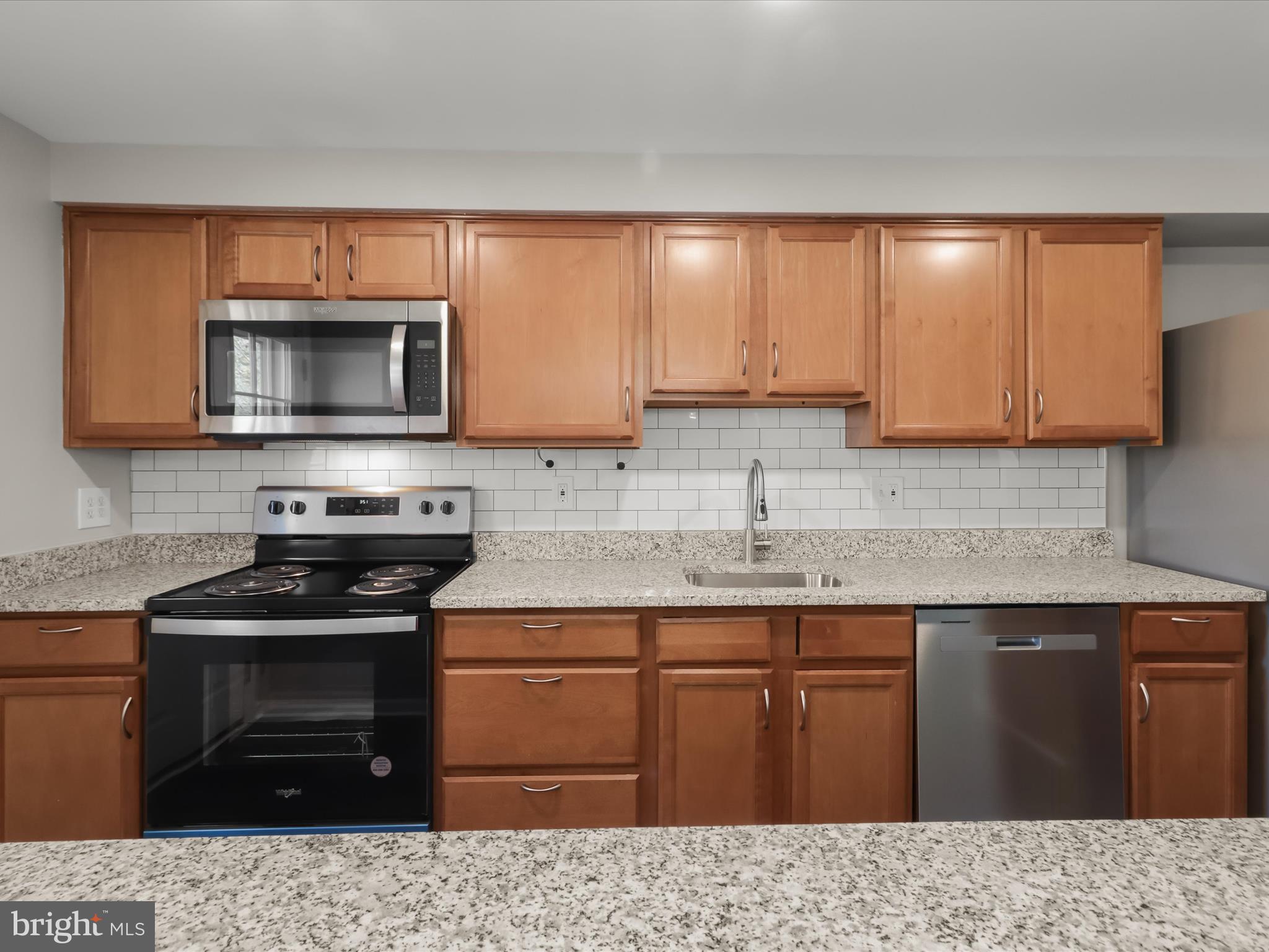 1026 Circle Drive Halethorpe, MD 21227 - Photo 15 of 37 a kitchen with a sink stove and microwave