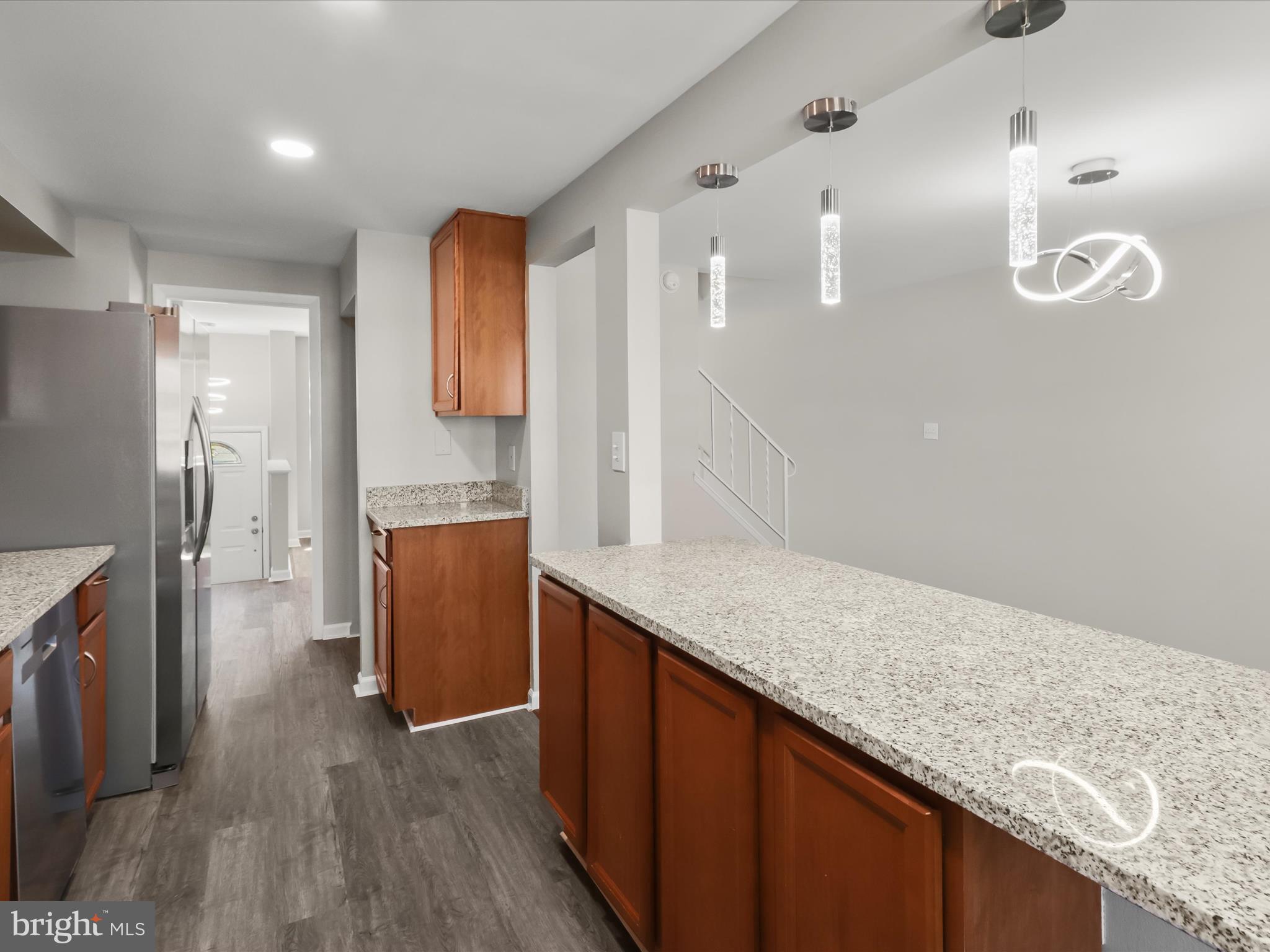 1026 Circle Drive Halethorpe, MD 21227 - Photo 20 of 37 a kitchen with granite countertop a sink and a refrigerator